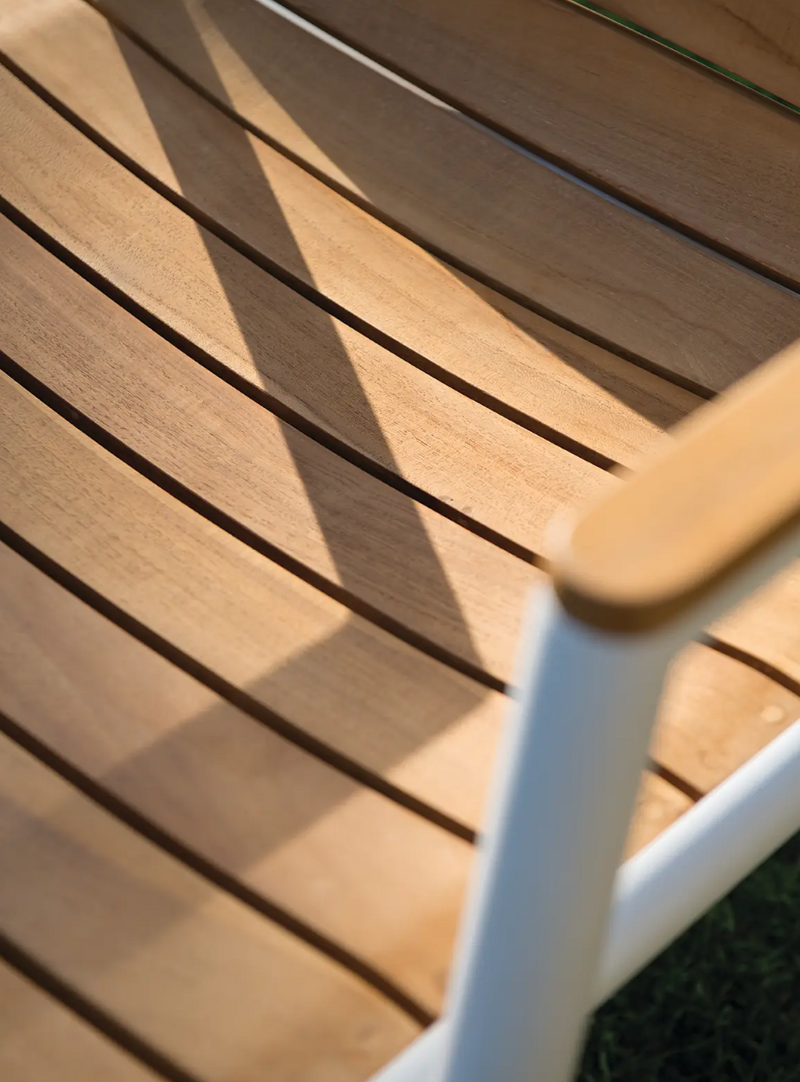 Load image into Gallery viewer, Fermob Pilotis teak armchair with curved armrests and slatted design, ideal for outdoor restaurant seating.
