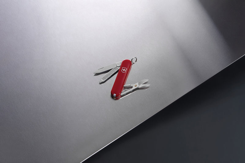 Load image into Gallery viewer, Victorinox Pocket Knife Classic SD with 7 functions, compact multi-tool with blade, scissors, and screwdriver, on a neutral background.