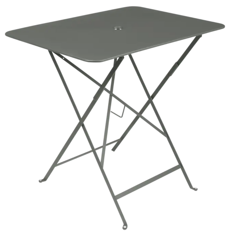 Load image into Gallery viewer, Fermob foldable bistro table in metal with 77x57 cm size, suitable for outdoor use, shown in a natural outdoor setting