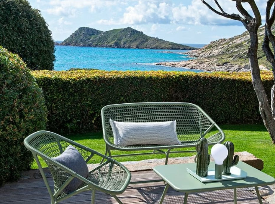 Outdoor Fermob Sixties Sofa with colorful cushions and modern design, perfect for stylish outdoor lounging.