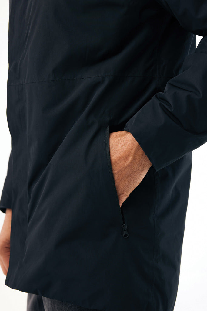 Load image into Gallery viewer, Iqoniq Thelon recycled polyester parka, close-up of textile material showing green fabric and textured surface.