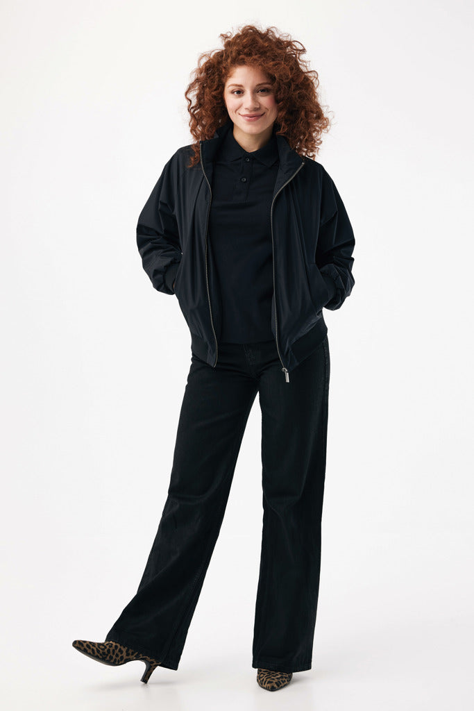 Load image into Gallery viewer, Iqoniq Odin recycled polyester urban jacket displayed on a hanger, showcasing its sleek textile design and modern fit.