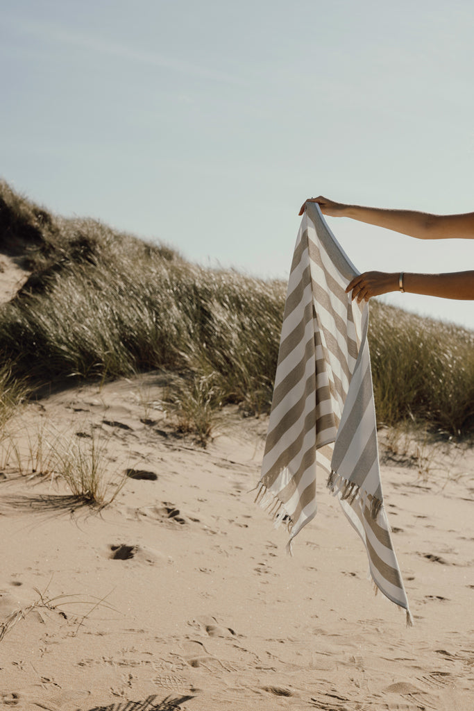 Load image into Gallery viewer, Vinga Ornos GRS recycled cotton hammam towel with striped pattern, folded on a wooden surface, showcasing eco-friendly home textile design.