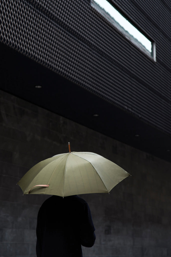 Load image into Gallery viewer, Vinga recycled pet 23-inch umbrella opened, showing green canopy with black handle and frame, eco-friendly design for rain protection.