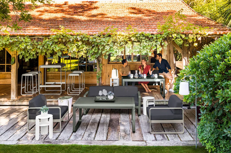 Load image into Gallery viewer, Fermob Bellevie armchair with metal frame and cushioned seat in a modern outdoor furniture design.