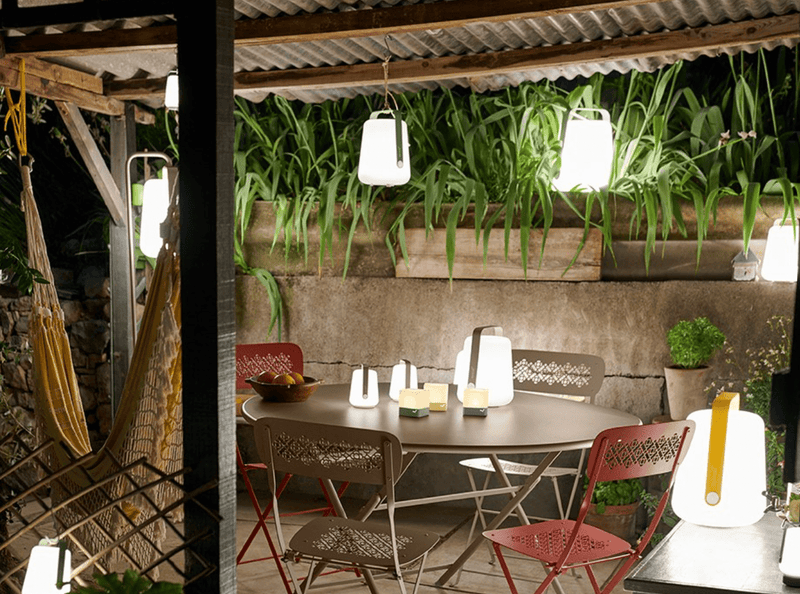 Load image into Gallery viewer, Fermob Caractère foldable metal table with 128 cm diameter, eight-seater, shown folded and open for outdoor dining.