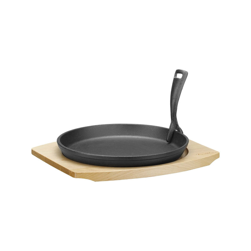 Load image into Gallery viewer, Cast iron serving pan Ø220mm with wooden base and handle, 270×230×(h)40 mm - Custom Wood DesignsCast iron serving pan with wooden base and handle, 220mm diameter, from Fine Dine, shown on a kitchen countertop.cast iron serving pan626900