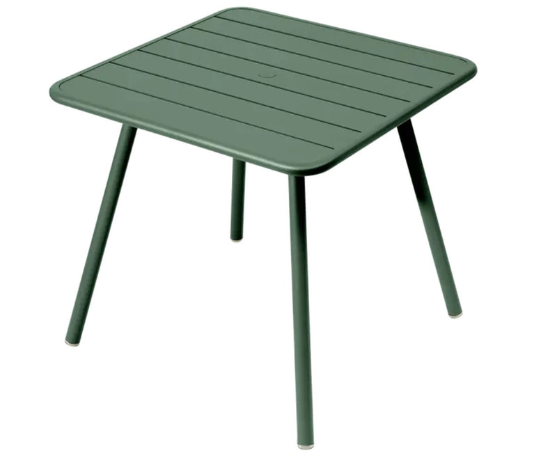 Load image into Gallery viewer, Green Fermob Luxembourg 4-leg metal garden table, 80x80 cm, with cedar-colored finish and sturdy design.