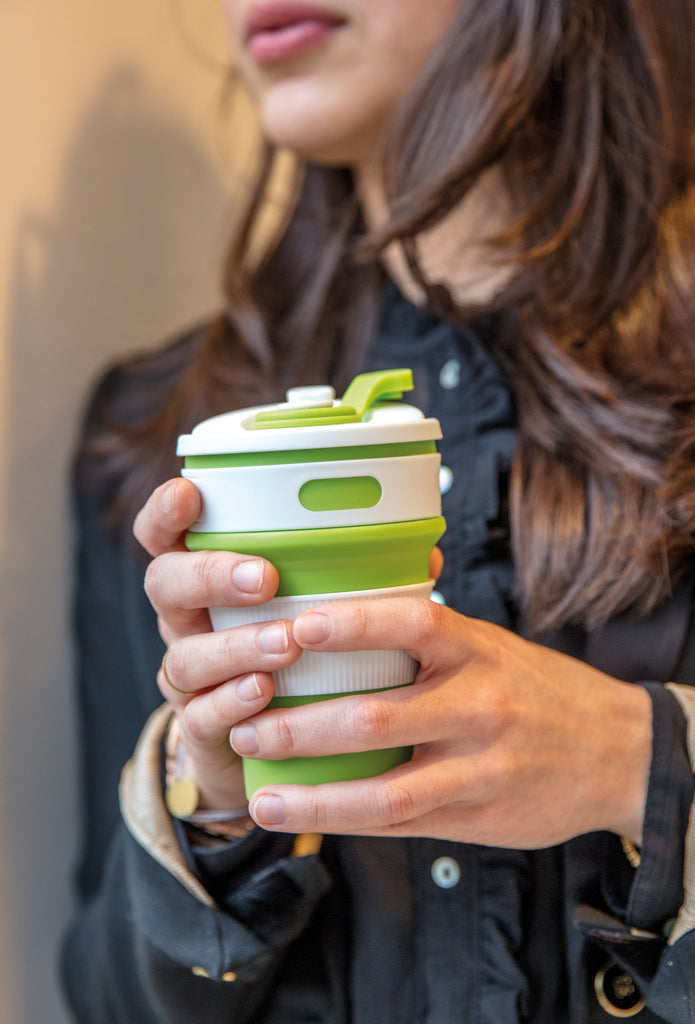 Load image into Gallery viewer, Foldable silicone drinkware cup by XD Collection, showing a compact, flexible silicone cup in a folded and open state for travel use.