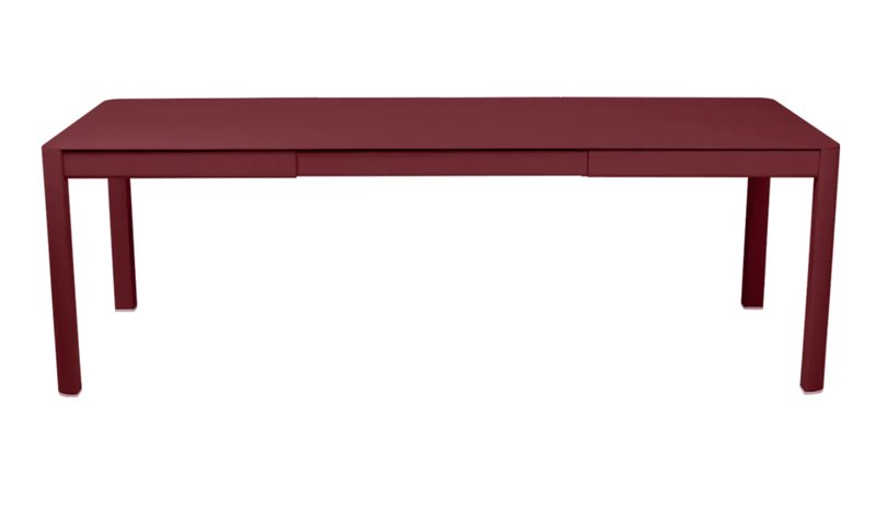 Load image into Gallery viewer, Chilli red Fermob Ribambelle extendable metal table outdoors, large 10-seater, perfect for outdoor hospitality and gatherings.