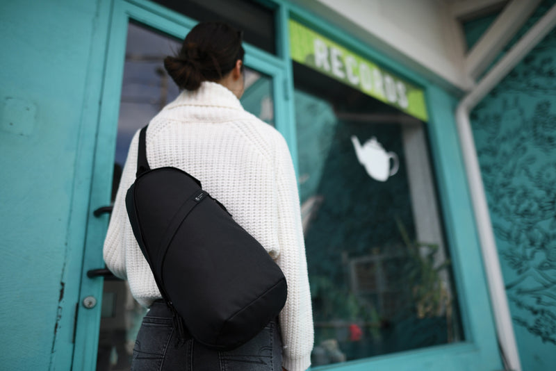 Load image into Gallery viewer, Renew AWARE™ rPET Sling Bag by XD Collection, eco-friendly bag made from recycled PET, with adjustable strap and minimalist design.
