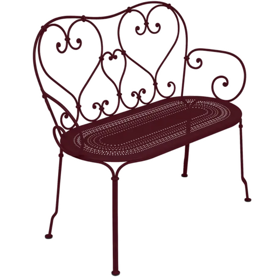 Decorative Fermob 1900 Bench made of metal with a vintage design, featuring curved armrests and a slatted seat.