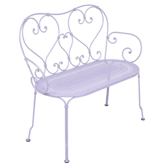 Decorative Fermob 1900 Bench with a colorful Marshmallow finish, showcasing its vintage-inspired metal design and vibrant style.