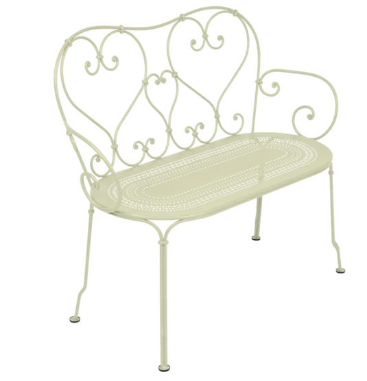 Fermob 1900 decorative bench with woven willow seat and curved metal frame, perfect for outdoor or garden seating.