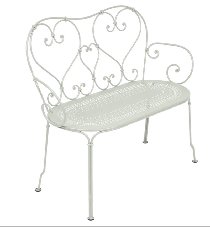 Load image into Gallery viewer, Fermob 1900 decorative clay-colored bench with curved metal design, ideal for outdoor or indoor seating.
