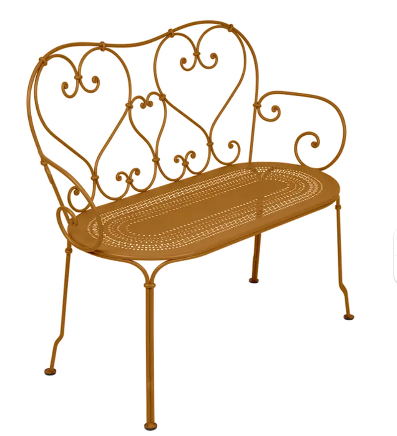 Load image into Gallery viewer, Fermob 1900 decorative bench with gingerbread-colored finish, featuring a vintage-inspired metal design for outdoor or indoor use.
