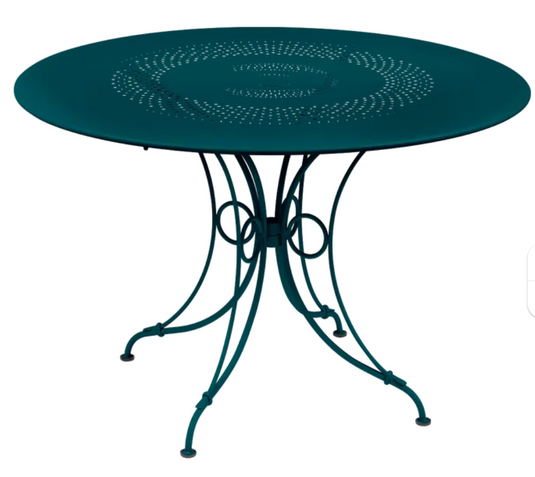 Fermob 1900 outdoor round table with 117 cm diameter, stylish metal table for garden or patio outdoor furniture.