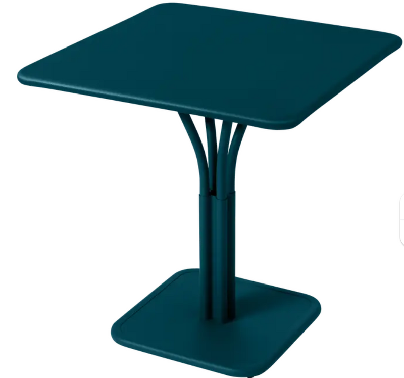 Load image into Gallery viewer, Blue Fermob Luxembourg metal table with a solid top, perfect for outdoor dining and patio settings.
