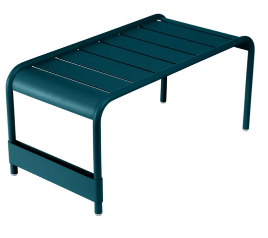 Fermob Luxembourg large low table and bench in a modern outdoor setting, measuring 86x44 cm, with a sleek metal design.