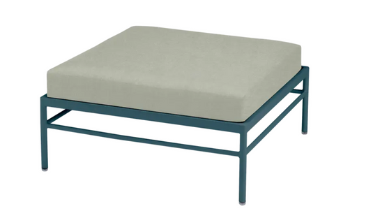 Fermob Rivage outdoor ottoman in Meadow Green with a metal frame, designed for comfortable outdoor lounging.