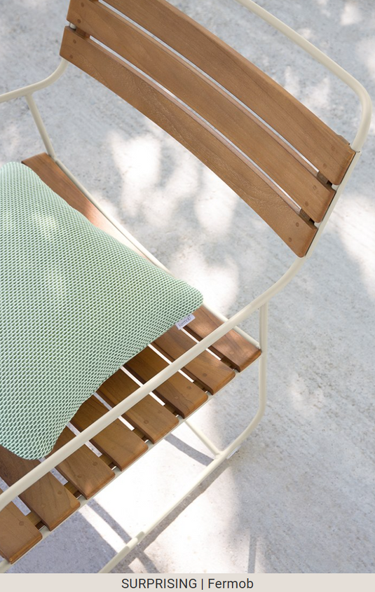 Fermob Surprising Teak Low Armchair, outdoor metal Acapulco-style chair with teak accents, suitable for garden or patio.