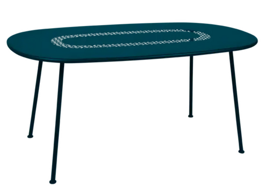 Fermob LORETTE oval metal outdoor dining table in Acapulco Blue, 160 x 90 cm, shown outdoors with a modern setting.