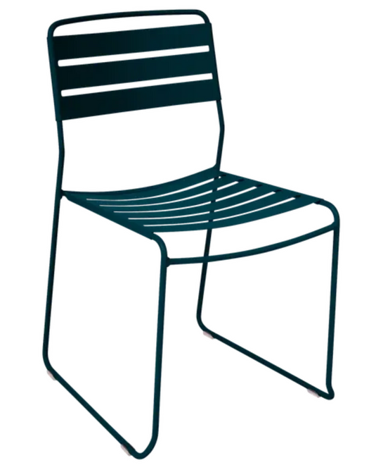 Blue Fermob Surprising outdoor chair with a curved metal frame, suitable for restaurant or patio outdoor seating.