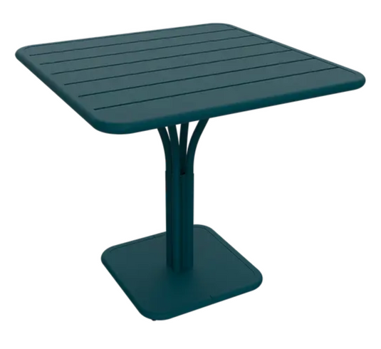 Luxembourg Fermob outdoor pedestal table in blue and white with 80x80 cm square tabletop, suitable for outdoor patio or garden.
