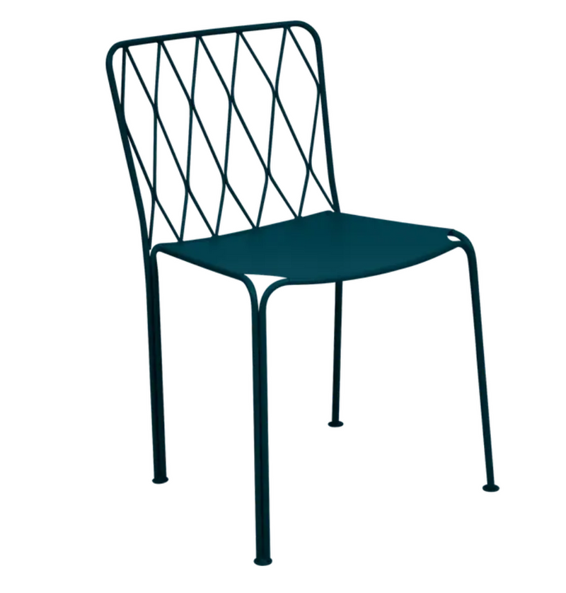 Load image into Gallery viewer, Stackable Fermob outdoor metal chair with a sleek design, suitable for restaurant or patio use, shown in a vibrant outdoor setting.
