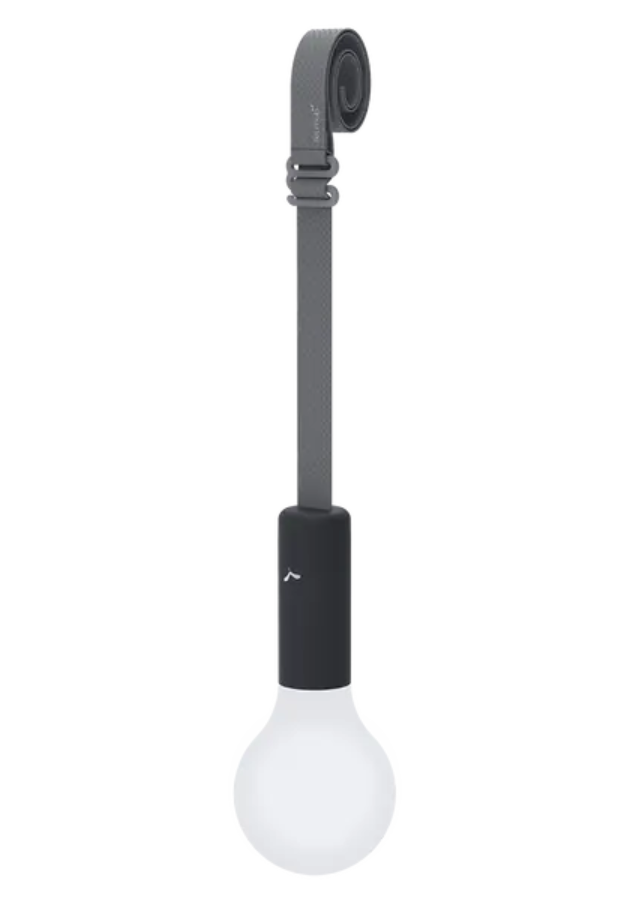 Load image into Gallery viewer, Fermob APLÔ suspended lamp with an anthracite finish and adjustable suspension strap, hanging as a stylish, rechargeable light.
