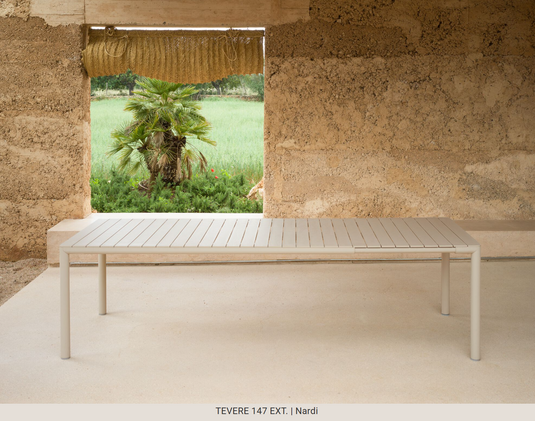 Nardi Tevere 147 extensible outdoor table by Custom Wood Designs, with an antracite finish, shown outdoors with extended surface.