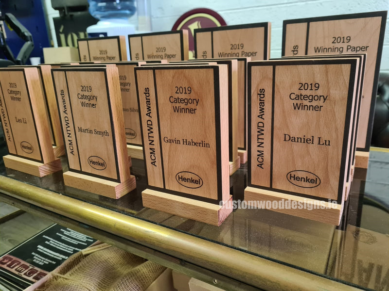 Load image into Gallery viewer, Custom wood awards with engraved branding from Custom Wood Designs, showcasing handcrafted award plaques on a wooden surface.
