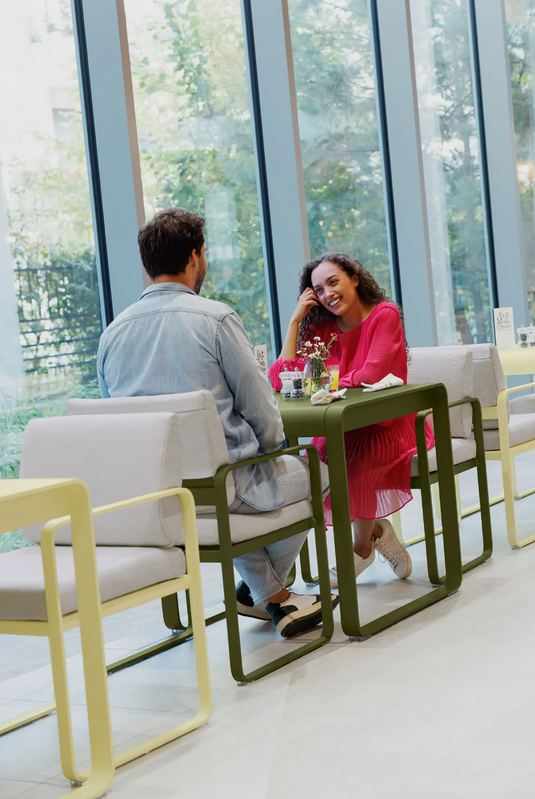 Fermob Bellevie outdoor dining armchair in nutmeg grey, featuring a stylish armrest design for outdoor seating.