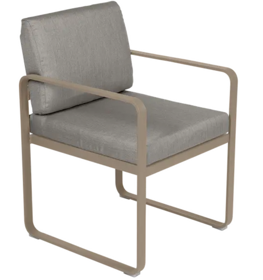 Fermob Bellevie outdoor dining armchair with a Nutmeg Grey/Toupe fabric cushion and sleek armrest design.