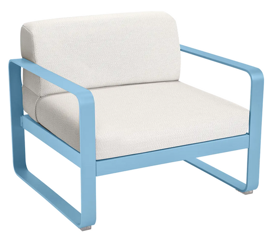 Fermob Bellevie armchair with a metal frame and cushioned seat, featuring a modern design and colorful fabric upholstery.