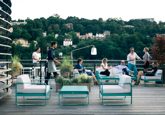Fermob Bellevie armchair with a sleek metal frame and cushioned seat, designed for modern outdoor or indoor seating.
