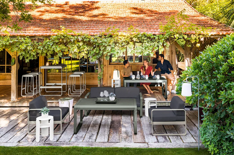 Load image into Gallery viewer, Fermob Bellevie armchair with metal frame and cushioned seat in a modern outdoor furniture design.
