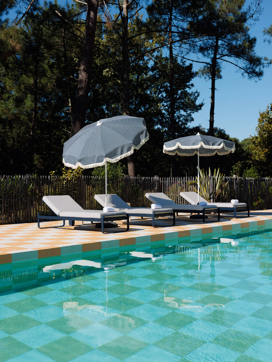 Fermob Bellevie Premium Sunlounger with adjustable backrest and cushioned seat in outdoor garden setting.