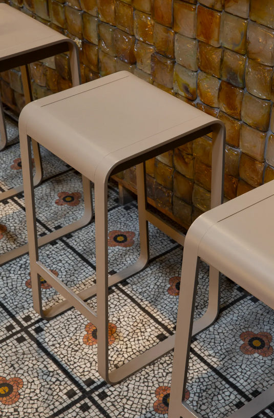 Fermob Bellevie high bar stool with sleek metal frame and wooden seat, suitable for outdoor kitchen or bar area.