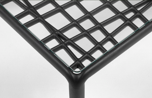 Nardi Komodo outdoor glass patio table with white glass top and sleek design, suitable for garden or patio use.