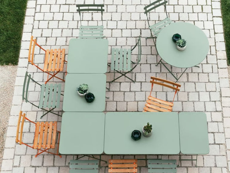 Fermob foldable metal bistro table measuring 97x57 cm, with a hole for outdoor dining, ideal for hospitality and hotel use.