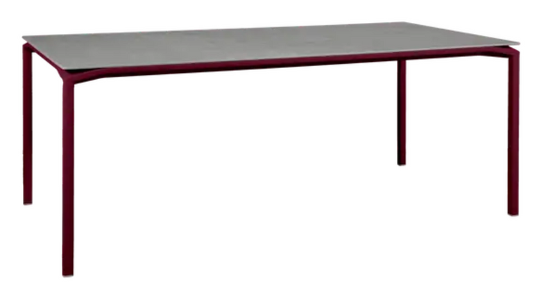 Load image into Gallery viewer, Fermob CALVI Kreta mineral dining table, 195 x 95 cm, black cherry finish, eight-seater with sturdy tabletop for outdoor dining.
