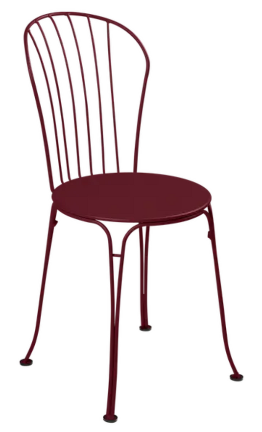 Black Fermob OPÉRA+ outdoor metal chair with a sleek black cherry finish, designed for outdoor restaurant seating.