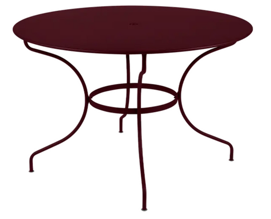 Black Fermob OPÉRA+ outdoor metal table with 117 cm diameter, six-seater design, ideal for garden or patio dining.