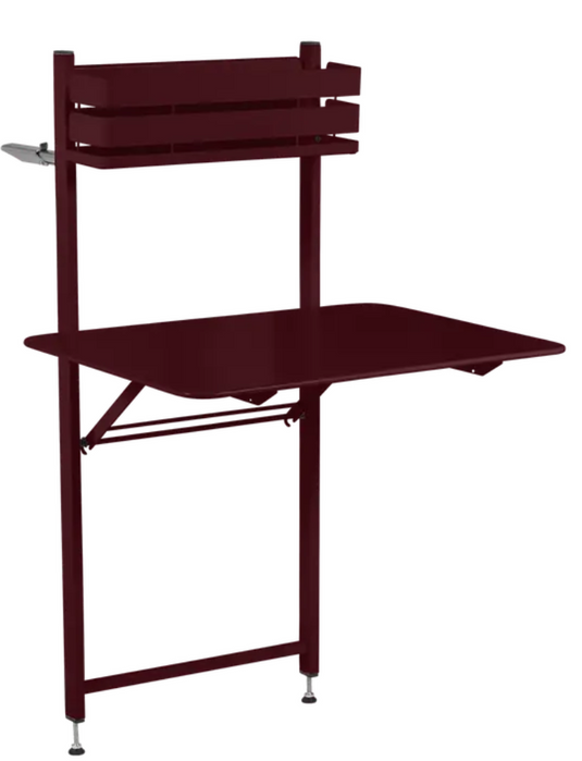 Black Fermob foldable balcony table with metal construction, suitable for apartments, outdoor use, and hotel room decor.