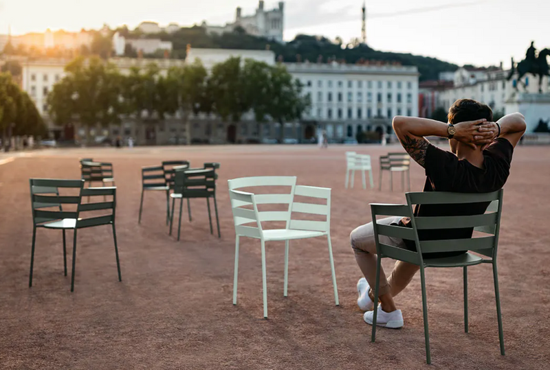 Load image into Gallery viewer, Fermob RYTHMIC outdoor armchair with a modern design, featuring a sleek metal frame and colorful woven seat for outdoor relaxation.

