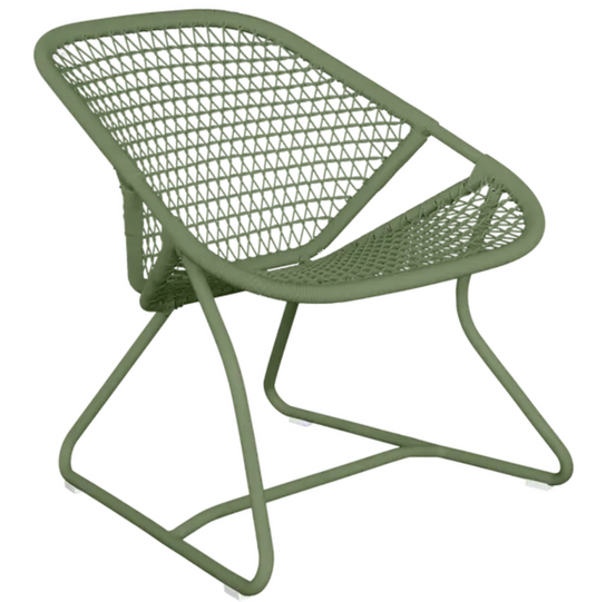 Woven Fermob Sixties Low Armchair lounge chair with a stylish design, featuring a natural woven texture and low armrest for comfortable seating.