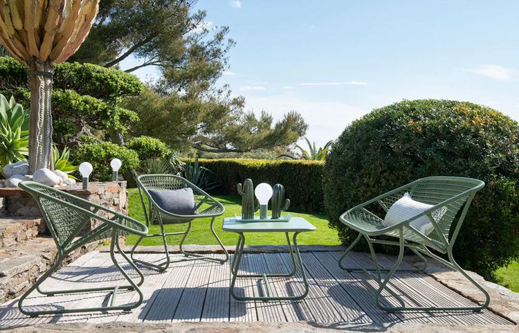 Cactus white Fermob Sixties Low Armchair woven lounge chair with low armrests, stylish furniture for modern interiors.