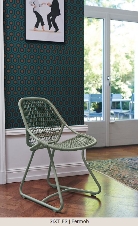 Stackable Fermob Sixties outdoor chair with a cactus green finish, designed for restaurant and hospitality outdoor seating.
