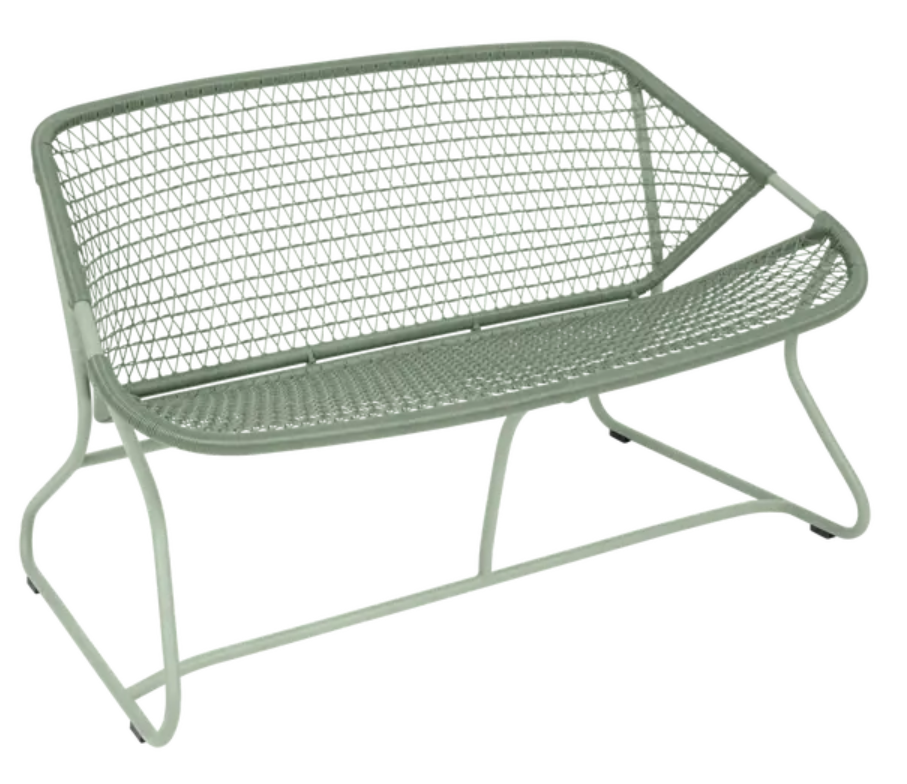 Fermob Sixties outdoor sofa with colorful cactus-patterned cushions, stylish garden seating for outdoor relaxation.